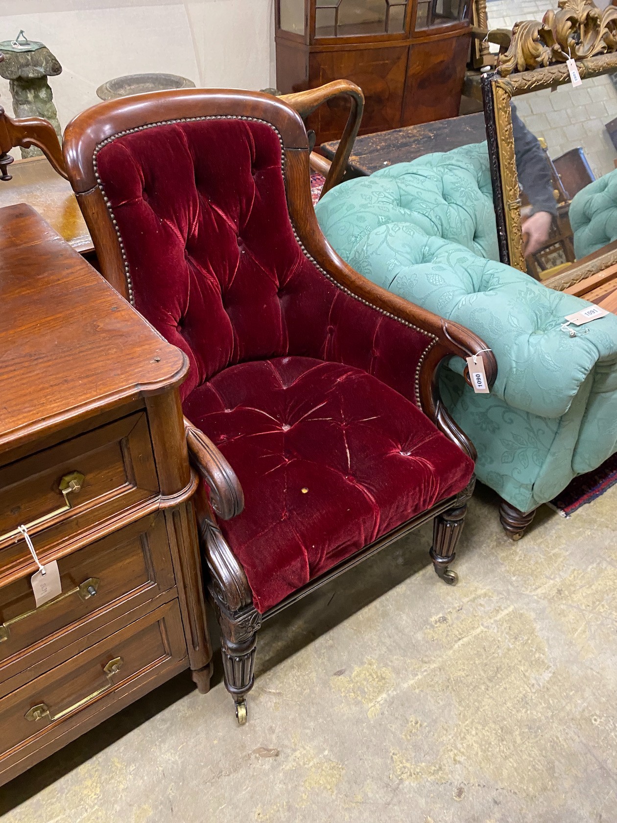 A Regency mahogany bergere chair now upholstered in a deep buttoned red fabric, width 59cm, depth 65cm, height 97cm